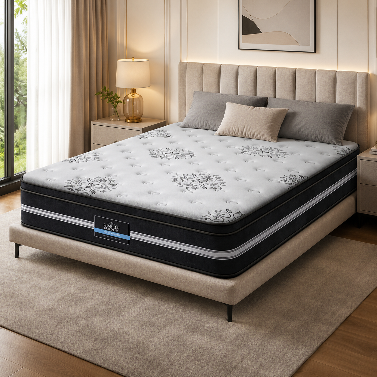 A tufted mattress on a upholstered bed frame in a styled bedroom. The mattress has a white top with gray floral tufting and black side panels with white stripes.